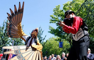 Gene Tagban, left, and Swill Kanim, right, open the naturalization ceremony with a Native American dance and musical performance.