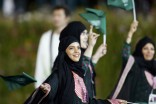 Saudi Arabian women Sarah Attar and Wodjan Ali Seraj Abdulrahim Shahrkhani (behind) take part in the opening ceremony of the London 2012 Olympic Games on July 27. They are the first women to represent Saudi Arabia in the Olympics. (REUTERS/Suzanne Plunkett)