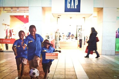 Kenyan children play with a donated soccer ball in part of the World Vision display at Northgate Mall. (Photo by Alex Stonehill)