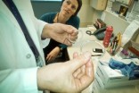Harborview STD clinic staffers Susannah Herrman and Sue Szabo discuss the drawbacks of earlier models of the Female Condom. (Photo by Mali Main)