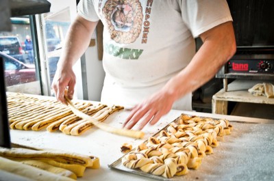 A baker at Piroshky Piroshky rolls together cinnamon cardamom braids. (Photo by Yvonne Rogell) 