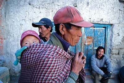 Loba farmers gather outside of Lo Manthang before a prayer ceremony. It is increasingly common for locals to be seen in western clothing, due to the new road which is nearly completed. (Photo by Taylor Weidman)