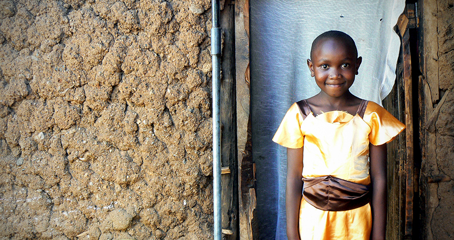 Jacktone Otieno's daughter Benta poses outside her home in Kibera, Kenya. Jacktone brags that Benta is at the top of her elementary school class. (Photo by Abby Higgins)