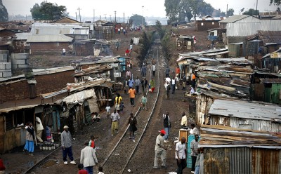 Beneath the overlapping tin roofs, residents of Kibera bustle between restaurants, grocery stores and pharmacies. Slums like these house one sixth of the world's population. (Photo by Alex Stonehill)