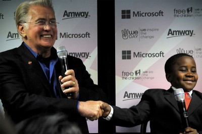 Martin Sheen shakes hands with YouTube celebrity Robby Novak, aka Kid President, at a WeDay press conference. (Photo by Sara Stogner)