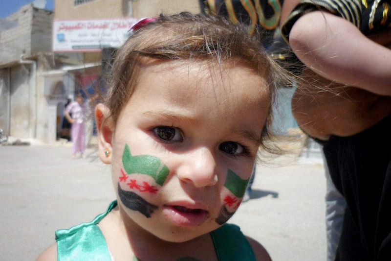 A young Syrian in Deraa, at a protest commemorating the massacre at Al-Houla last May, where over 100 women and children were allegedly killed by pro-government militias. (Photo by  Syrian Revolution Memory Project)