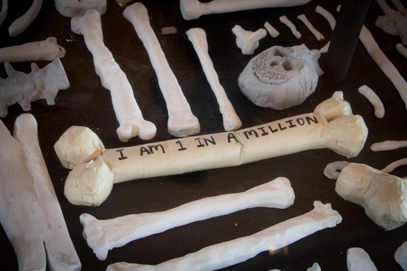 Replicas of human bones line the floor of [storefront] in Pioneer Square. (Photo by Christian Zerbel)