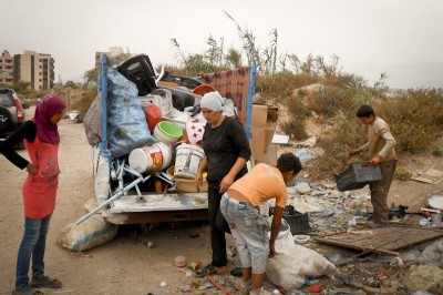 Syrian refugees collect recyclables in Hay al-Tanak. Poor Lebanese residents in the slum are beginning to resent the presence of Syrian refugees. (Photo by Justin Salhani) 