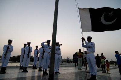 Soldiers lower the Pakistani flag in Karachi. (Photo by Alex Stonehill)