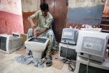 Used computer monitors imported from overseas are polished for retail at an electronics market in Karachi, Pakistan. (Photo by Alex Stonehill)