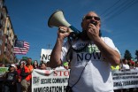 Jorge Quiroga leads the crowd chants during the May 1st immigration reform march. (Photo by Ian Terry)