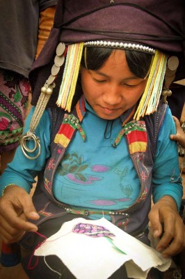 A member of the OckPopTok cooperative in Laos embroidering. (Photo courtesy International Folk Art Market).