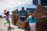 From left; first generation Samoan youth Roselle Savea, Naiasolagi Ulusago, Nathan Taupau and Evangeline Taupau at a carwash to benefit the Aso Fitu Samoa Church on the sidewalk of International Boulevard in Tukwila, Wash. (Photo by Ian Terry)