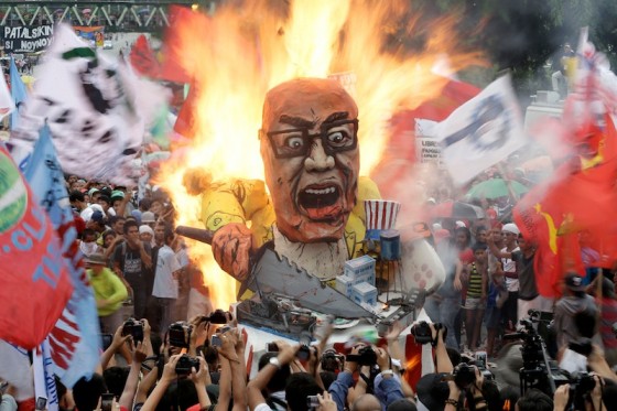 Protesters burn an effigy of Philippine President Benigno Aquino III during a rally to coincide with his fourth State-of-the-Nation Address (SONA) on Monday July 22. (Photo by Bullit Marquez / AP)