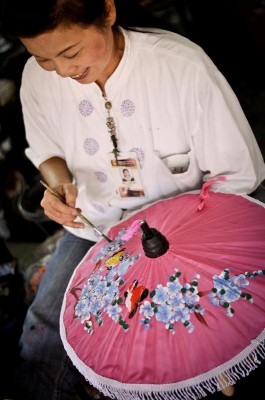 An artisan paints an umbrella at a factory outside Chiang Mai, Thailand. (Photo by Marat Garafutdinov)