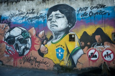  mural in Rio critiquing preparations for the World Cup in 2014 reads, "They destroyed my community on account of the Cup" (Art by Metro Mangueira, Photo by Nick Wong)