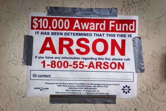 A sign posted outside Med Mix soliciting tips on the yet unsolved arson case. (Photo by Alex Stonehill)