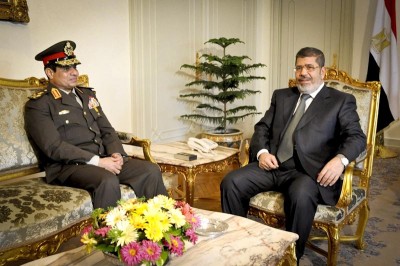 Mohammed Morsi (right) during happier times with his Defense Minister General Sisi, who deposed him in July. (Photo via The Egyptian Presidency)