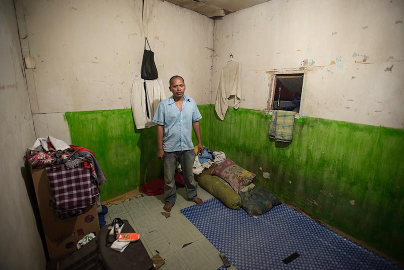 An Indonesian garment factory worker in his one room apartment. Prevailing wages in the garment industry are rising, but still only make up 22% of an estimated "living wage" in Indonesia. (Photo by Branden Eastwood)