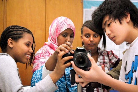 Seattle World School students Keristian, Dulamsuren, Kumneger, and Bao learn digital photography. (Photo by Sara McCaslin)