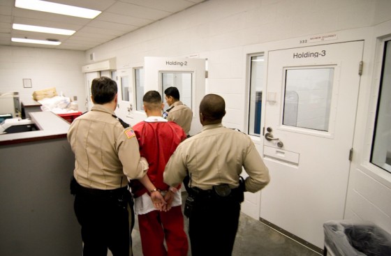 An undocumented immigrant is booked into the Northwest Detention Center in Tacoma. (Photo by Alex Stonehill)