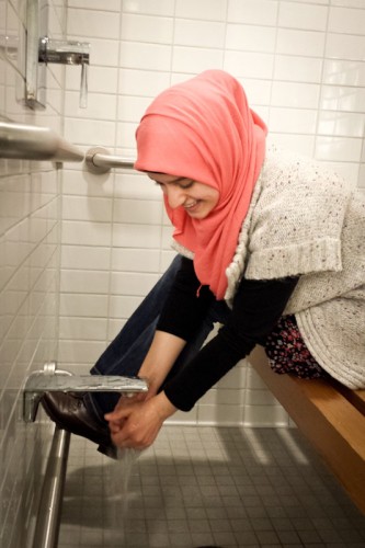 Meva Beganovic completes the traditional Muslim ablution procedure before entering the prayer room at the UW HUB. (Photo by Annie Wilson)
