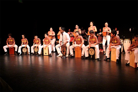 Miguel Ballumbrosio, an international artist and music director, performs "Cajón Peruano" with local youth using traditional wooden drums or "cajons". (Photo by Aida Solomon)