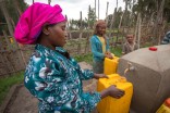 Ethiopian women fill up jugs at a water point constructed by a Seattle-based NGO. (Photo courtesy Water 1st International)