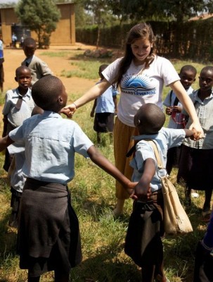 President and founder of Richard’s Rwanda-IMPUHWE Jessica Markowitz grasps hands with Rwanda students in the village in Nyamata during the organization’s annual trip to Rwanda in the summer of 2011. (Photo courtesy of Lori Markowitz)