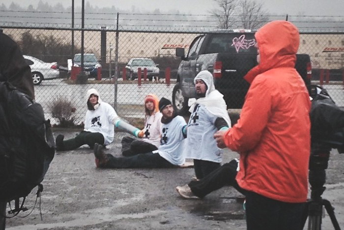 Activists chain themselves together to block deportation vans in Tacoma on Monday. (Photo by Jill Mangaliman)