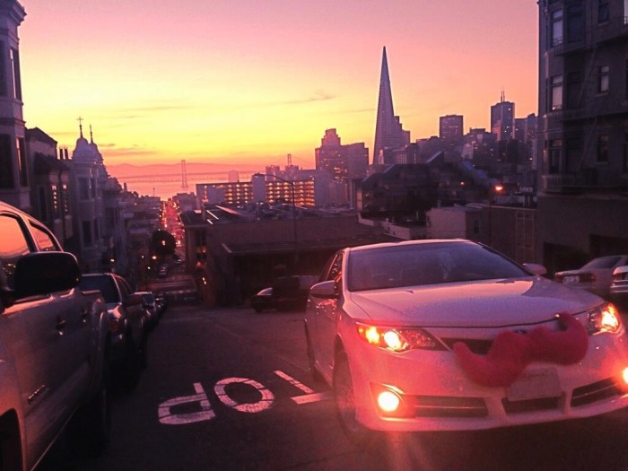 A car sports the unmistakable pink mustache of Lyft’s ridesharing service. (Photo courtesy of Lyft) 