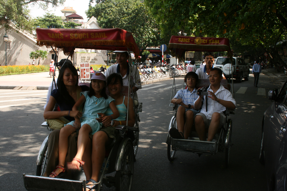 The author (second from right) riding city pedicabs with his family in Saigon, Vietnam in 2007.