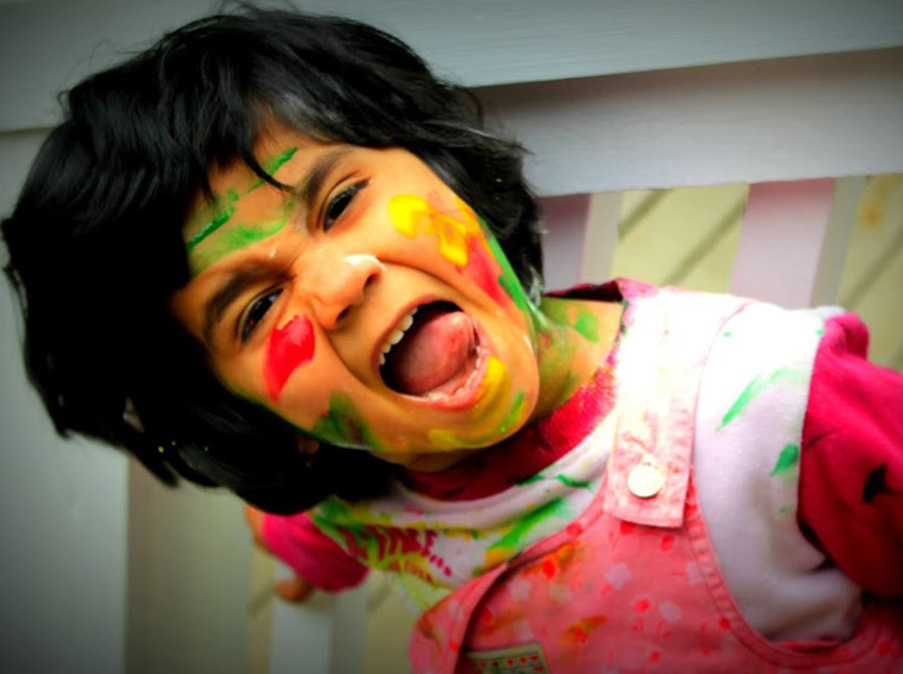 The author's daughter, Ditti, showing off her colors for Holi last year. (Photo by Padmaja Ganeshan-Singh)