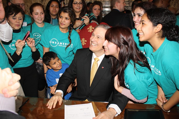 Gov. Jay Inslee signing the Washington State Dream Act. (Photo thanks to OneAmerica)