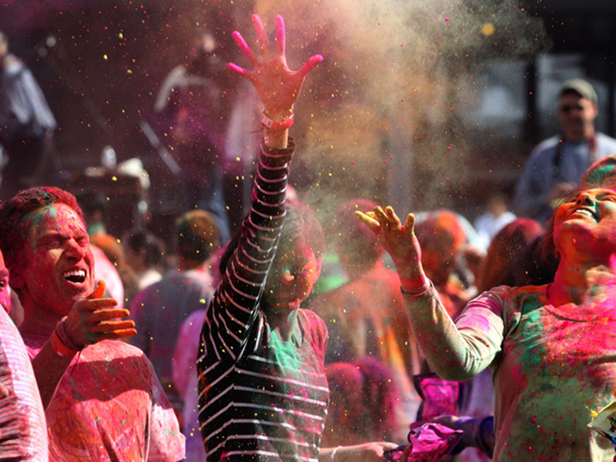 Festival goers go all out on Holi last year in downtown Redmond. (Photo by Alan Brenner)