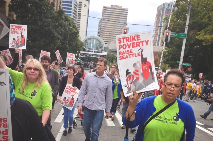 Monica Smith (right) marches in support of a $15 minimum wage in Seattle earlier this year. (Photo by Reagan Jackson)