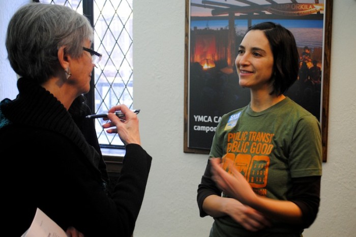 Rebecca Saldaña, Deputy Director at Seattle think tank Puget Sound Sage, connects with a community member at a public meeting about the Transportation Benefit District, last month.