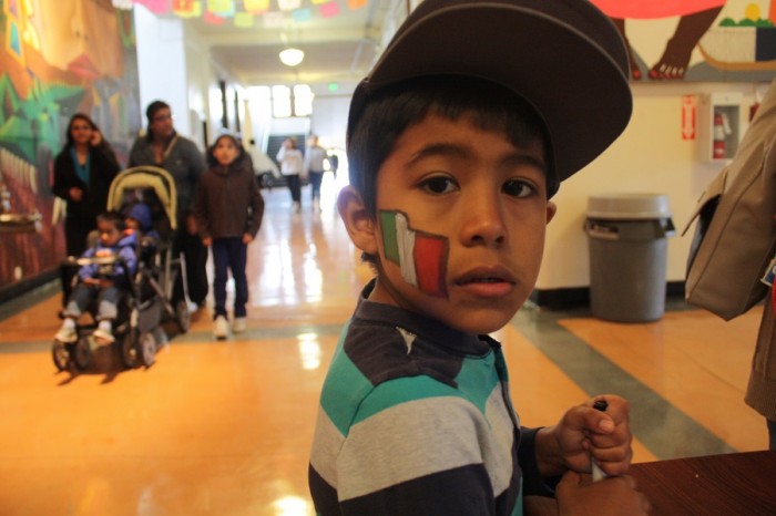 Chistopher Rojas, 6, shows the Mexican flag painted on his cheek during Cinco de Mayo at El Centro de la Raza. Passing on tradition to a new generation was an important aspect of this year's celebration. 