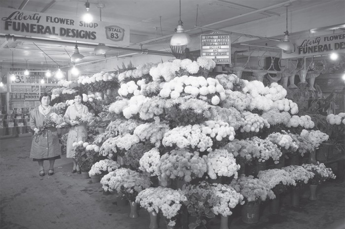 A Japanese-American-owned Liberaty Flower Shop at Pike Place Market, ca.1931. By fall of 1907, nearly 80% of the stalls were operated by Japanese farmers. The photo is part of the "Grit" exhibit at the Wing Luke Museum. (Photo courtesy of Washington State Historical Society)