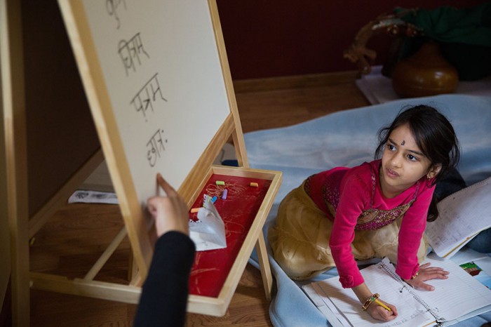 Sahana Samrat, 5, right, pays close attention to the written Sanskrit words on a whiteboard taught by Sowmya Joisa, left, at a children's Sanskrit language class, in Newcastle, on Saturday, May 10, 2014.  (Photograph by MARCUS YAM/The Seattle Times)