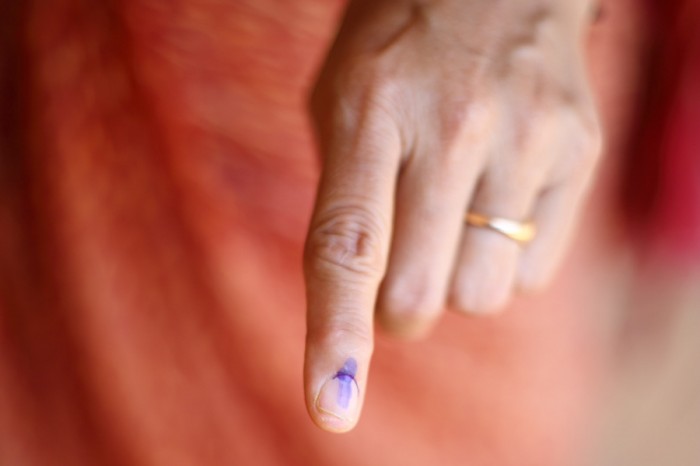 Election ink is applied to a voter's index finger after casting their ballot in the Lok Sabha elections in India. (Photo by Jane D'Souza)