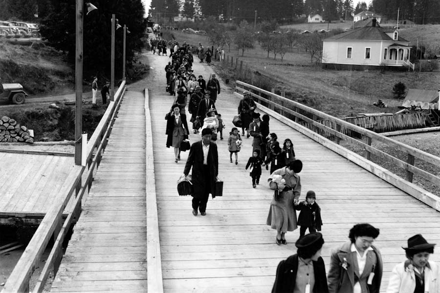 Japanese Americans walk down the Bainbridge Islan ferry dock to catch a special ferry to Seattle for mass removal in 1942. (Photo courtesy of the Museum of History & Industry)