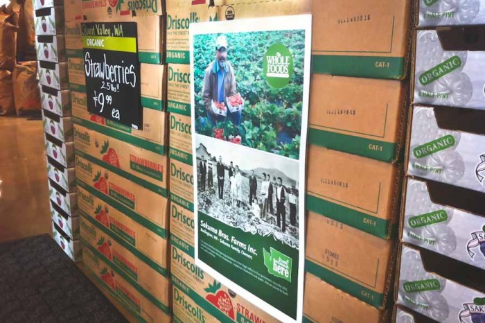 A display at the Whole Foods in South Lake Union advertises berries sourced from Sakuma Bros. Farms. The Skagit County farm will pay out a $850,000 settlement to berry pickers it abused last season. (Photo by Alex Stonehill)