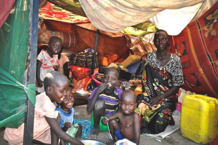 A family in a makeshift shelter at a UN compound in South Sudan. Over a million people have been displaced by the conflict. (Photo via OCHA)