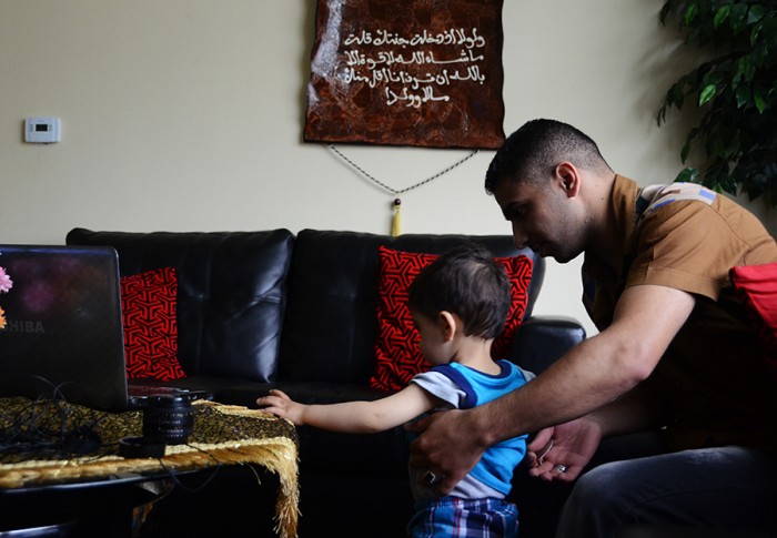 Ali Al-Khazaraji plays with his youngest brother in their home in Kent. (Photo by Alisa Reznick)