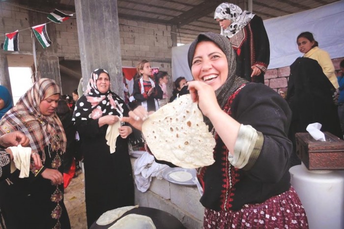 Women making bread at a celebration in Gaza. (Photo by Karin Huster)