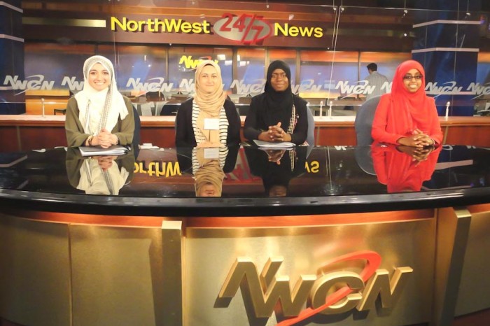 Participants in the Muslim Youth Leadership Program pose for a photo behind the Northwest Cable News desk. (Photo courtesy CAIR-WA)