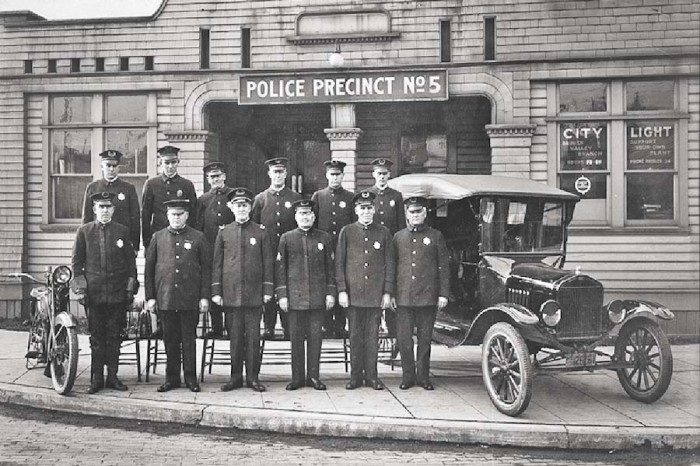 Times have changed. The Seattle Police Department's 5th precinct in 1921, when their fanciest piece of equipment was a Model-T Ford. (Photo from Seattle Municipal Archives)
