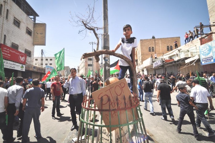 A young Palestinian from Hebron at a protest against Israeli military action in Gaza in early August. (Photo by Thomas James)