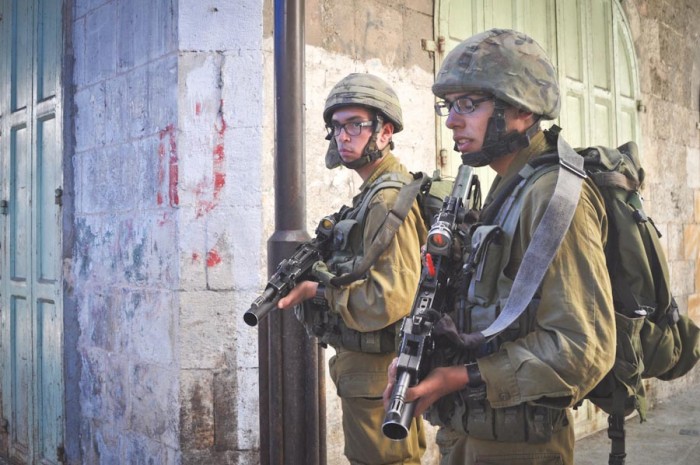 Israeli soldiers patrol a Palestinian protest in Hebron earlier this month. (Photo by Thomas James)